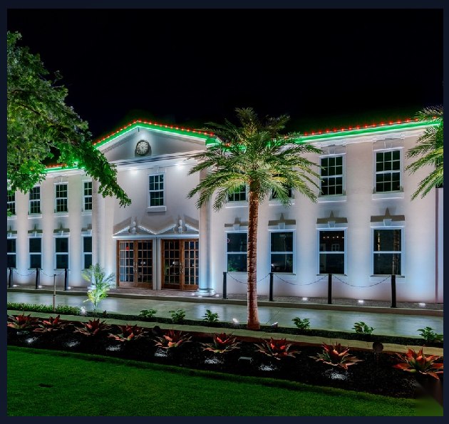Commercial building with red and green programmable architectural lighting along the roofline
